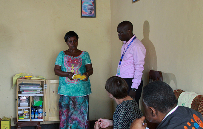 Marie Josee Mukankuranga explains how she counsels women on family planning during a visit by development experts. © UNFPA/Rick Francis