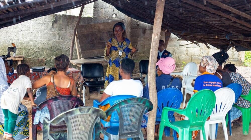 A woman gives a presentation to a group of people.