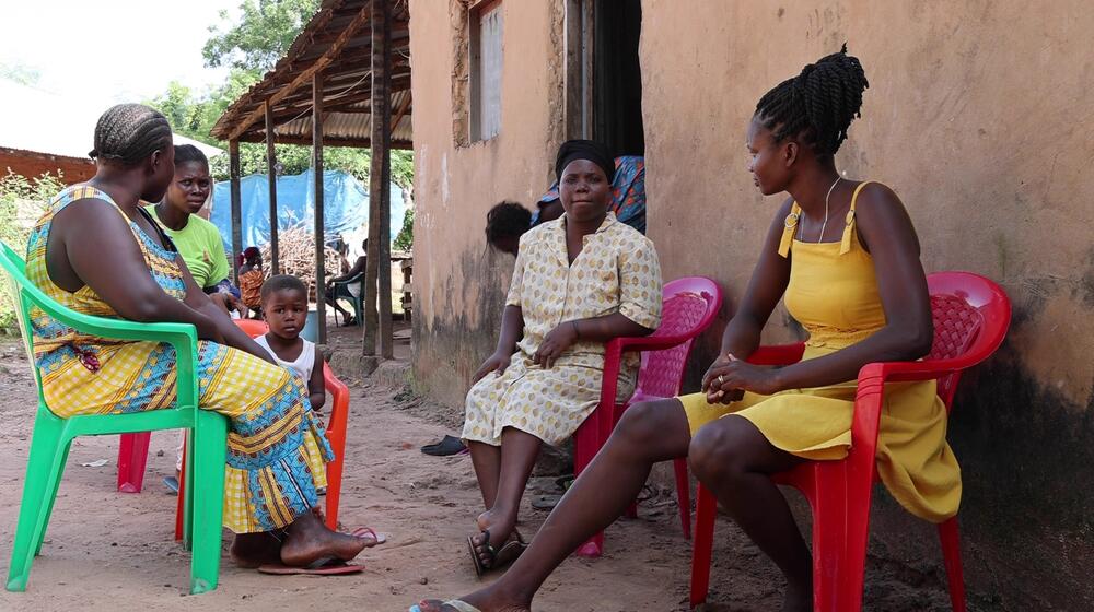 A family sits together in a circle.