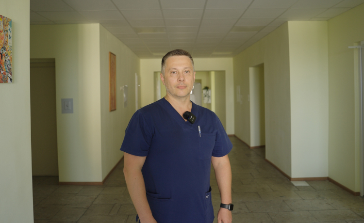 A doctor stands in a hospital corridor