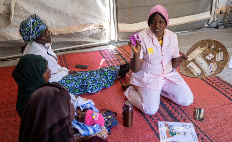 UNFPA-supported midwife Maria Akouya informs Sudanese refugee women about the different kinds of contraception methods available at a health centre in the Farchana refugee camp. Credit: © UNFPA Chad / Karel Prinsloo