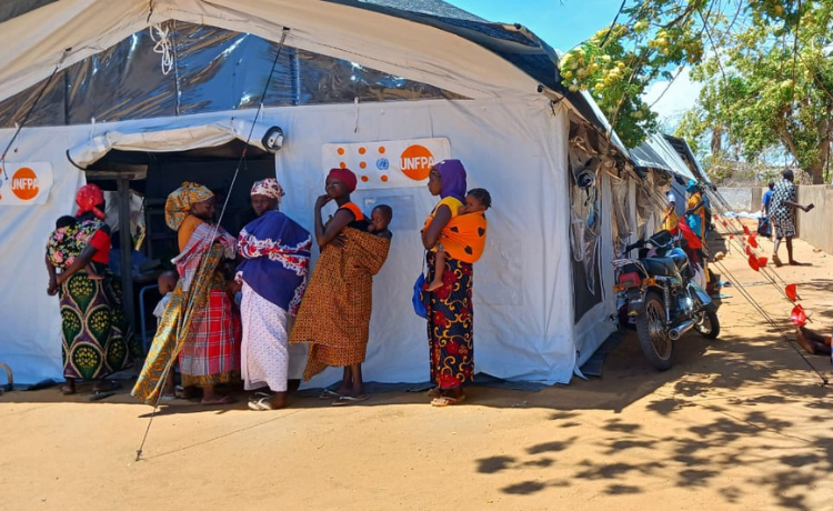 Women with newborns line up outside a UNFPA tent