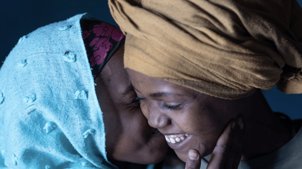 Two girls smiling. 